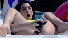 Petite Riley Jean toys pussy in the pool and sucks big cock